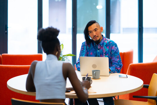 Colleagues Working With A Laptop In The Office.
