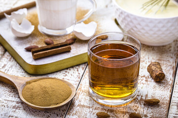 preparation of Christmas eggnog, Christmas drink recipe, with eggs, sugar, cinnamon, rum and cream