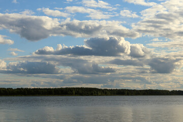 Colorful sky on the background of a lake and a forest