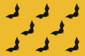 Black paper bat on a white background. Halloween concept. With a hard black shadow. View from above.