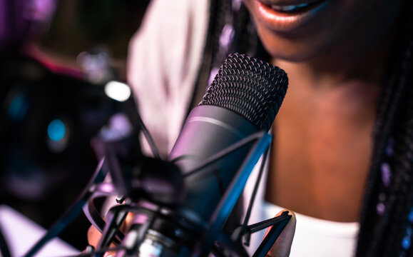 Woman speaking into a studio microphone
