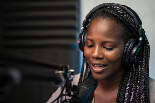 Woman speaking in a podcast studio