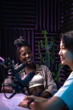 Two women recording a podcast