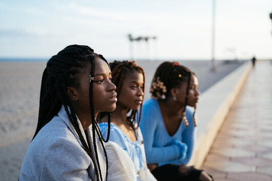 Black women resting on beach together