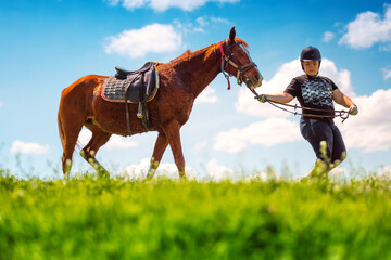 Young Boy riding a horse in the field