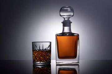 Cognac or brandy glass isolated on gray white background with clipping path. Decander with cognac or brandy