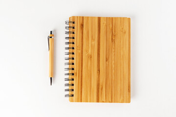 bamboo notebook and pen on a white background