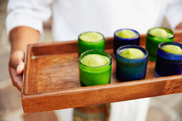 Service person holding a tray of frozen smoothies