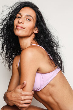 Sexy latino model wearing a purple swimsuit