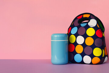 snack on a break with a lunchbox. colorful handbag, blue thermos. lunch for a schoolboy or an...