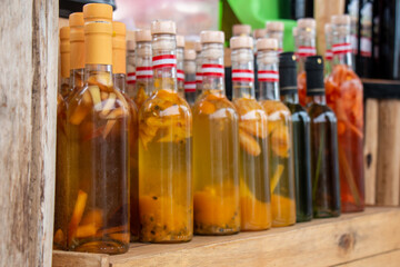 Bottles of artisan liquor, macerated with various fruits. Bottles of colors and shapes. Peruvian liquor