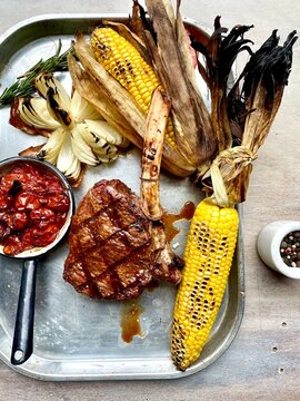 Tomahawk steak and grilled corn