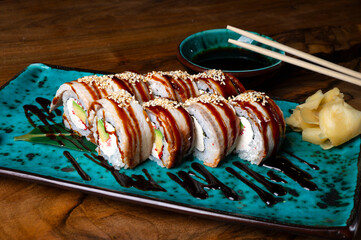 Sushi set with red fish on the table on blue dishes