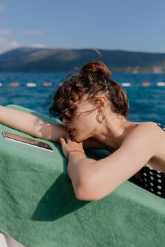 Woman Sunbathing On The Dock
