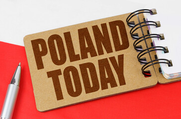 On the flag of Poland lies a notebook with the inscription - Poland today