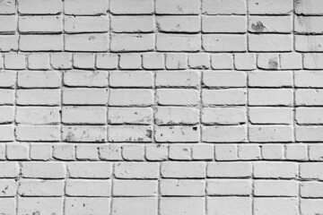 Texture of a brick wall with cracks and scratches which can be used as a background