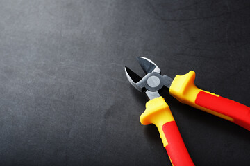 The pliers tool is red on a black background with a free space