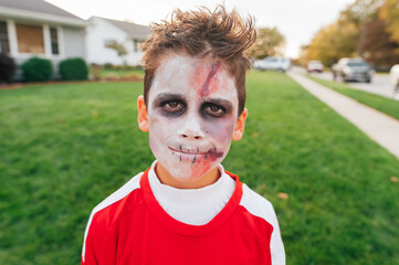 Boy with creepy face paint on. 