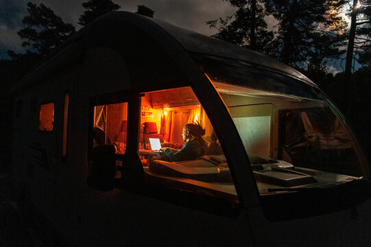 Man using laptop in camper van