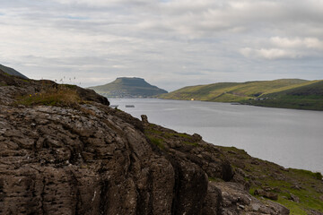 Fototapeta na wymiar Beautiful view of the Cains - rock stacking in fort of the ocean bay in the Faroe Islands