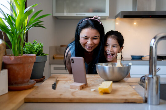 Cheerful family doing a video chat at kitchen 