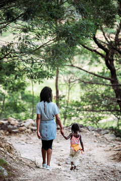 black family walking on path in woods