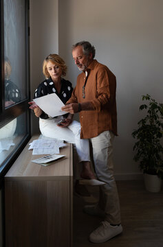Senior couple looking documents at home