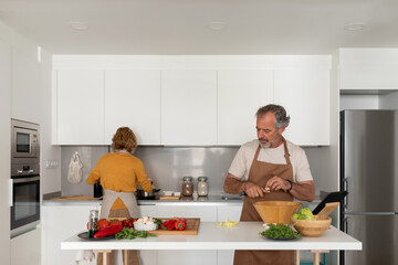 Mature couple cooking together at home