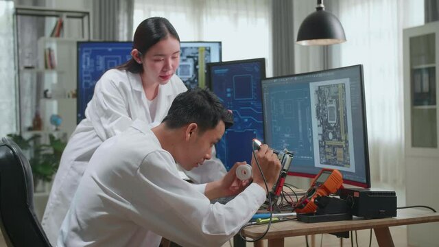 Modern Electronics Development Facility: Asian Team Of Multi Engineers, Scientists Work On Computer, Talk, Design Pcb, New Generation Silicon Microchips, Manufacturing Semiconductors
