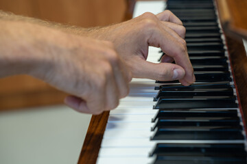 Fototapeta na wymiar Play the piano. Hands on the piano keyboard.