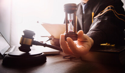 justice and law concept.Male judge in a courtroom on wooden table and Counselor or Male lawyer working in office. Legal law, advice and justice concept.