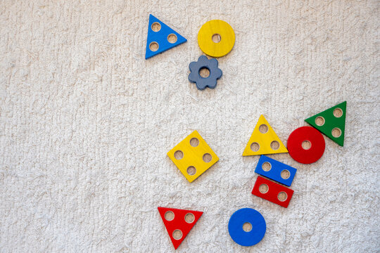 Wooden toys placed on carpet in room