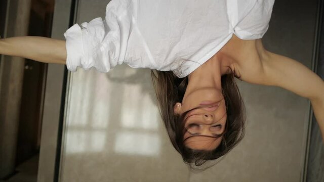 an attractive young girl dancing sensually in a white sheet. Attractive and sexy girl. High quality FullHD footage