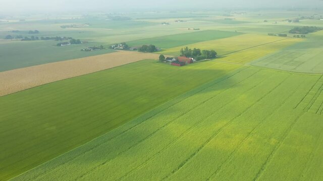 Aerial view footage of remote rural country landscape with fields of crops