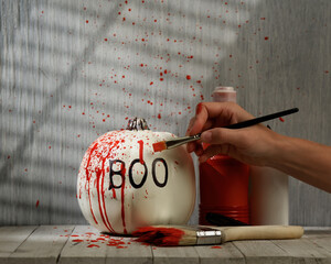 Decorating Pumpkin with Red Paint at Home