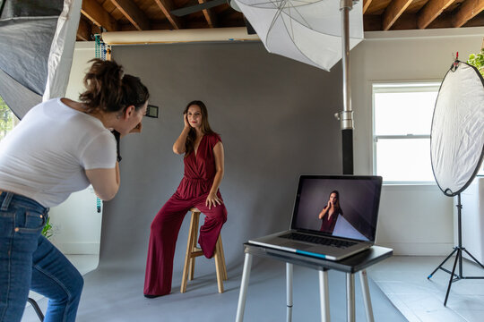 Woman Shoots Model in Photo Studio with Laptop