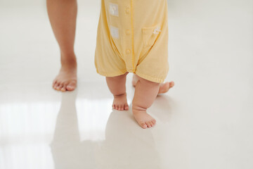 Close up of  mother teaching toddler daughter to walk