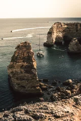 Papier Peint photo Plage de Marinha, Algarve, Portugal Playa rocosa con barco