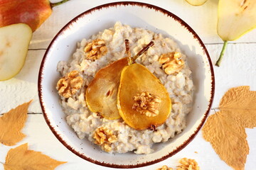 Porridge with caramelized pear and walnuts. Nutritious autumn breakfast