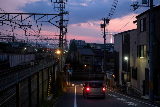 Driving cars in the streets, in the evening of the Japanese city background

