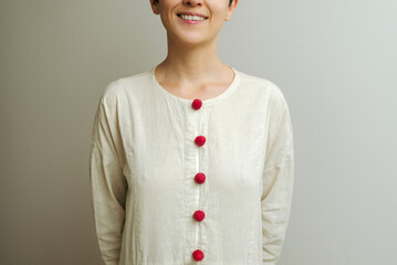 Young woman in linen dress with raspberries on buttons