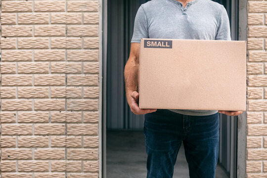 Storage: Man Holding Carboard Box By Unit Door