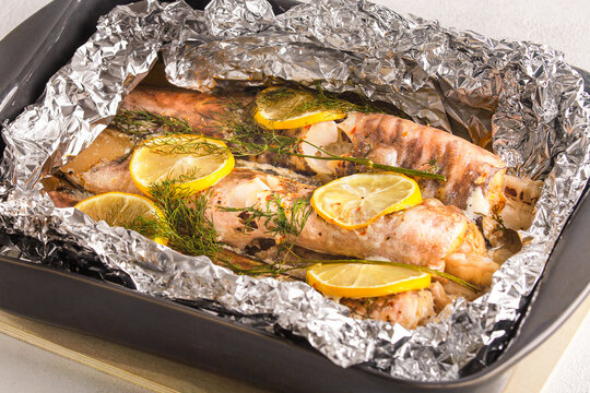 Fish congrio cooked, baked in foil with lemon and dill.
