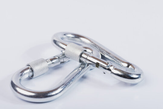 Metal snap hooks on a white isolated background.Spring carabiner made of stainless steel, heavy duty carabiner with quick release lock. 
