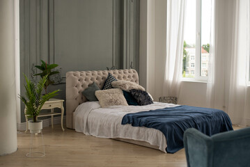 Fototapeta premium Pillows closeup in nicely decorated bedroom in blue and white colors