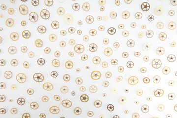 Small gears spread out on a white background