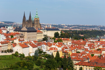 Fototapeta premium Autumn Prague City with gothic Castle and the colorful Nature with Trees from the Hill Petrin, Czech Republic