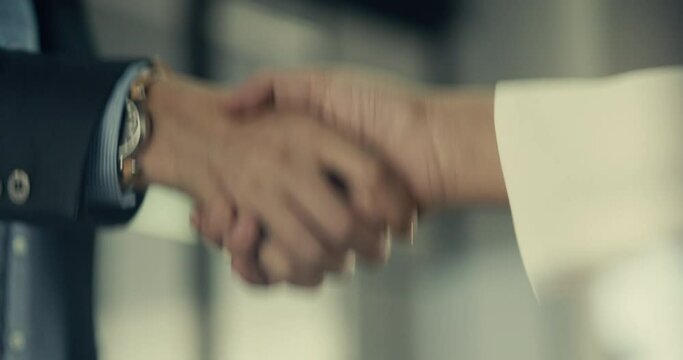 Shaking hands in the office
