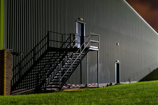 Metal stairs on a modern factory building at night