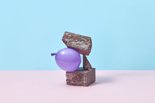 Balloon squeezed between stones